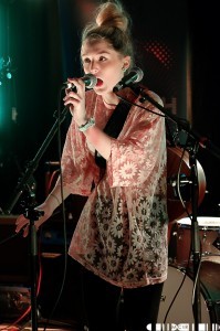 "a happy, confident performer with real stage presence – she attacks that mic with some vigour"