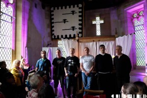 Male gaelic singers  of Trosg performing in the capel. Full hosue for a calm intimate set with folks listening in from outside